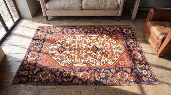 Tribal geometric herati design small antique ivory persian malayer rug 2 Tribal geometric herati design small antique ivory persian malayer rug (sku 21204) - styled overhead view