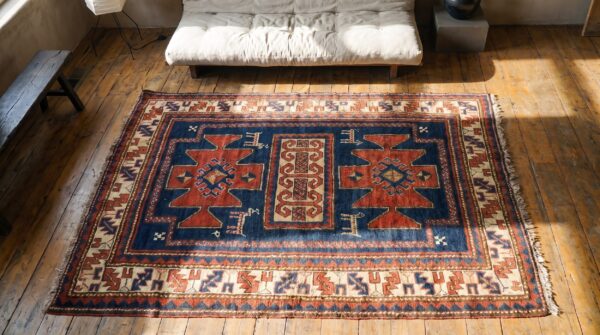 Antique tribal primitive design hand knotted wool pile blue caucasian rug 2 Antique tribal primitive design hand knotted wool pile blue caucasian rug (sku 19576) - styled overhead view