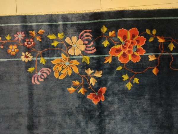 Navy blue color field antique floral pattern chinese deco rug by walter nichols 19 Navy blue color field antique floral pattern chinese deco rug by walter nichols, detail photo 12, stock number 25227