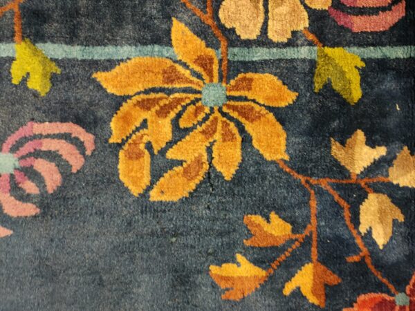Navy blue color field antique floral pattern chinese deco rug by walter nichols 20 Navy blue color field antique floral pattern chinese deco rug by walter nichols, detail photo 13, stock number 25227