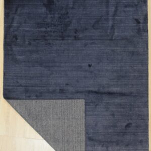 Navy blue solid rug with one corner folded to show the woven back (SKU OCU90NV8X10)