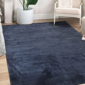 Navy blue solid rug styled in a bright living room (SKU OCU90NV8X10)