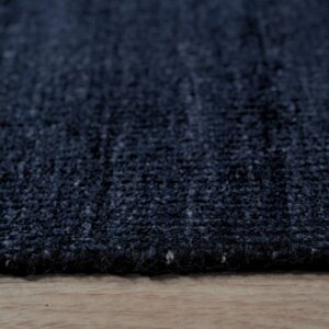 Close view of the pile and bound edge of a navy blue rug (SKU OCU90NV8X10)